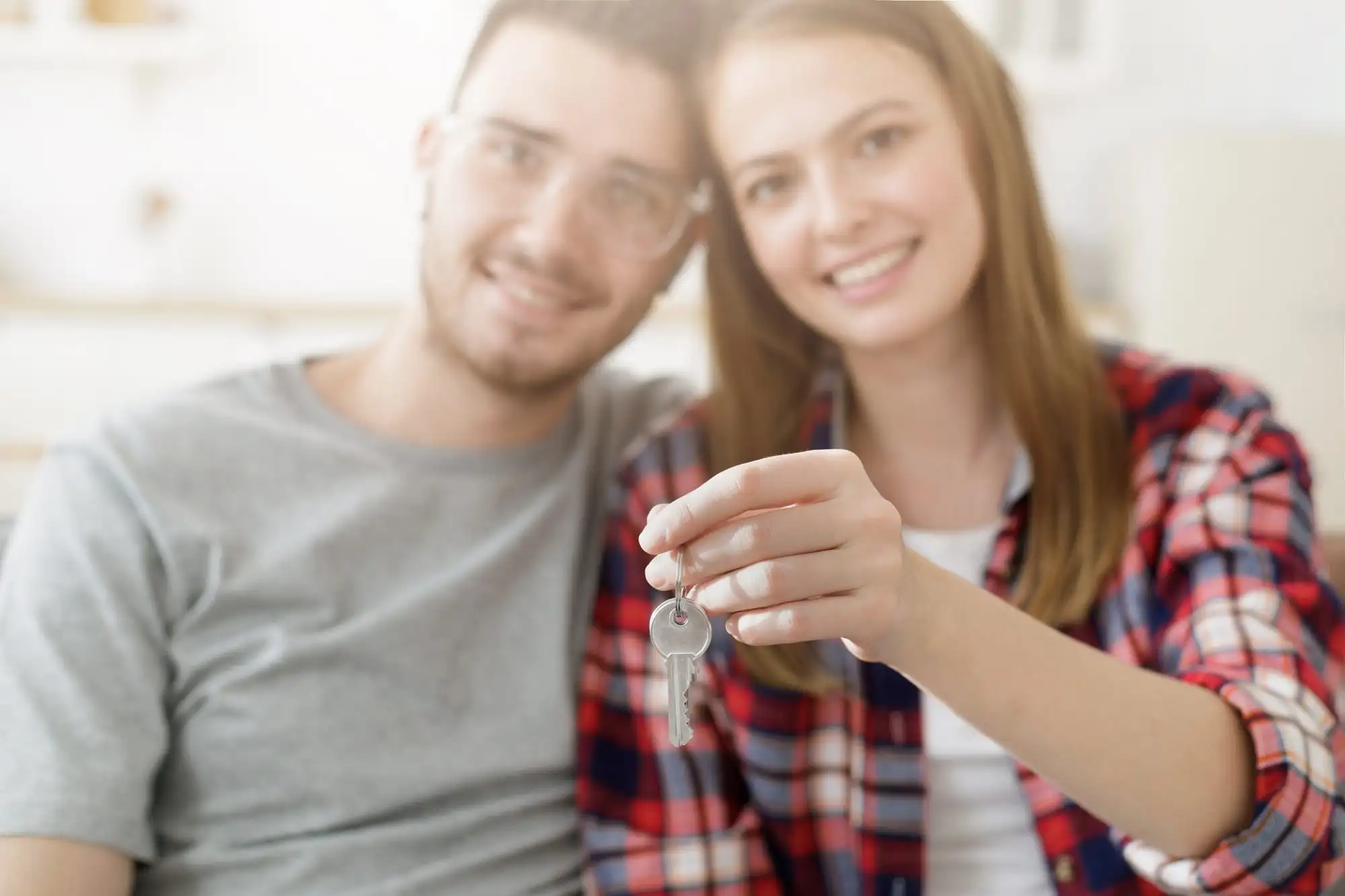 Couple holding keys to a new home