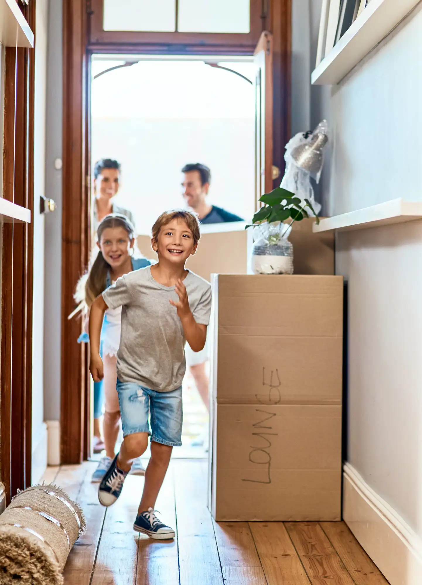 Kids running into their new home on moving day
