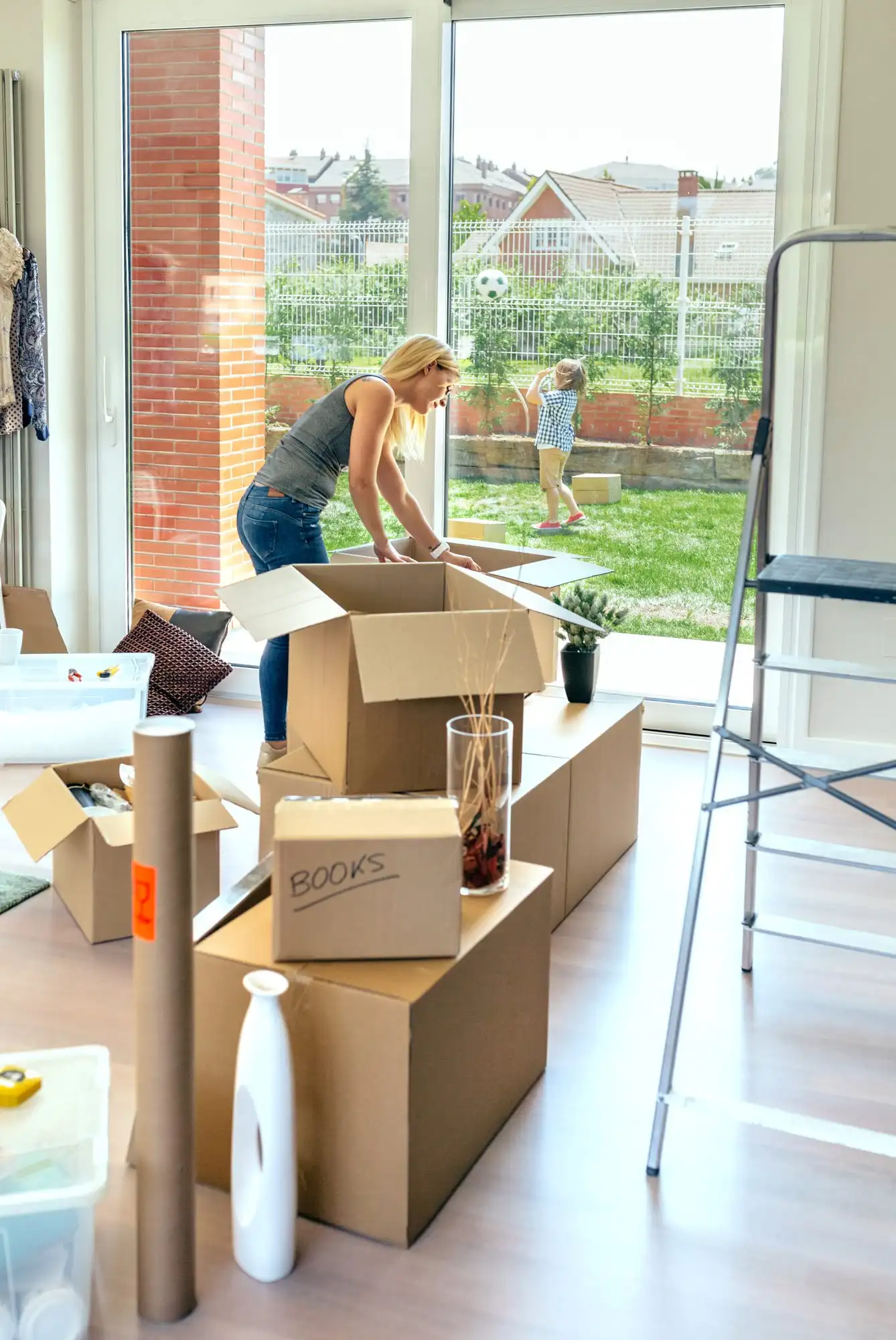 A parent and child moving into a new home