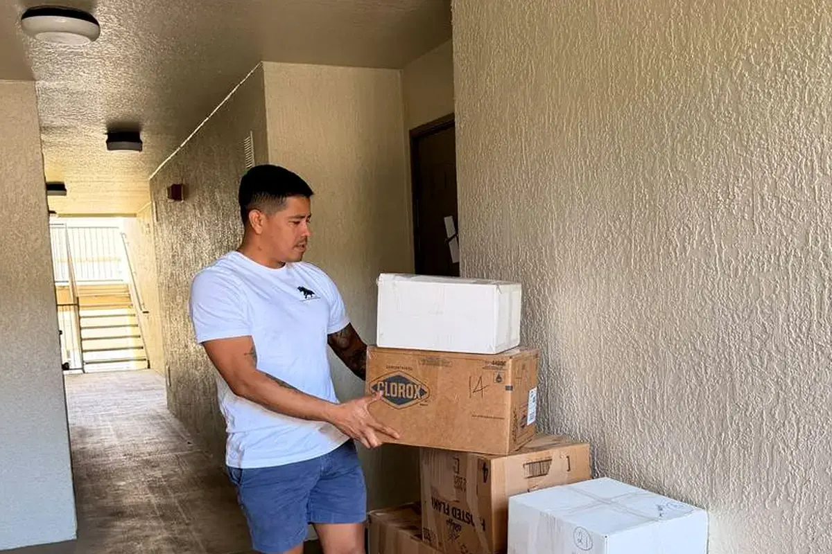 Toro Movers handling boxes in an apartment hallway on a real Orlando-area complex move